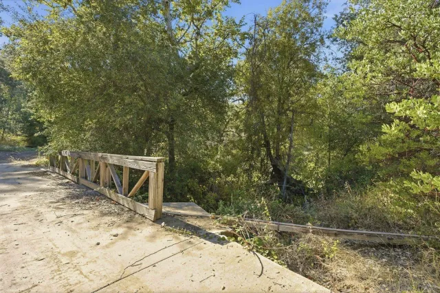 a view of a park with iron fence