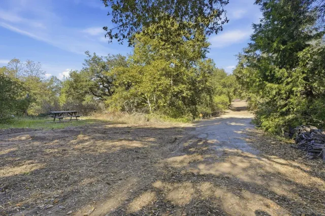 a view of balcony with wooden floor and fence