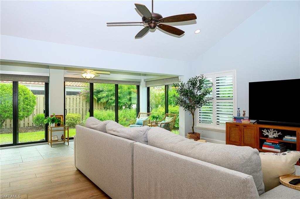 719 Reef Point Circle, Unit 13 Naples, FL 34108 - Photo 15 of 29 a living room with furniture and a flat screen tv