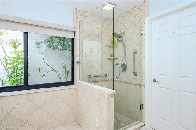 a bathroom with a bathtub and a shower