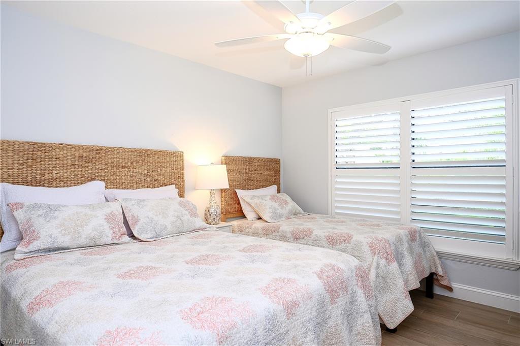 719 Reef Point Circle, Unit 13 Naples, FL 34108 - Photo 21 of 29 a bedroom with a large bed and a large window