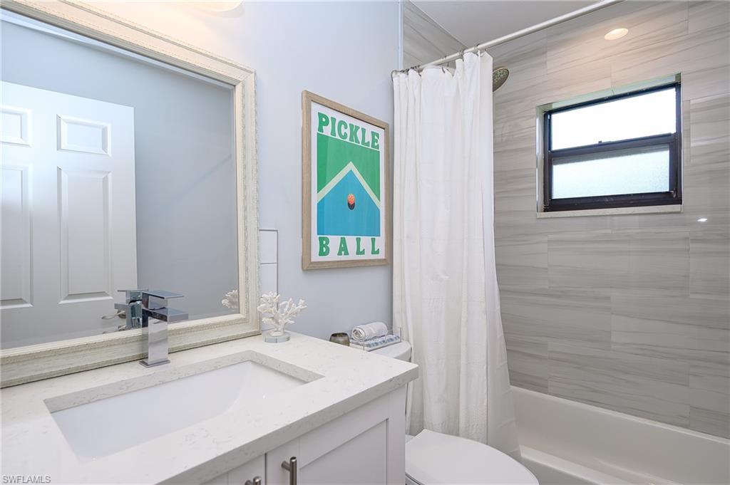 719 Reef Point Circle, Unit 13 Naples, FL 34108 - Photo 22 of 29 a bathroom with a sink a toilet and shower