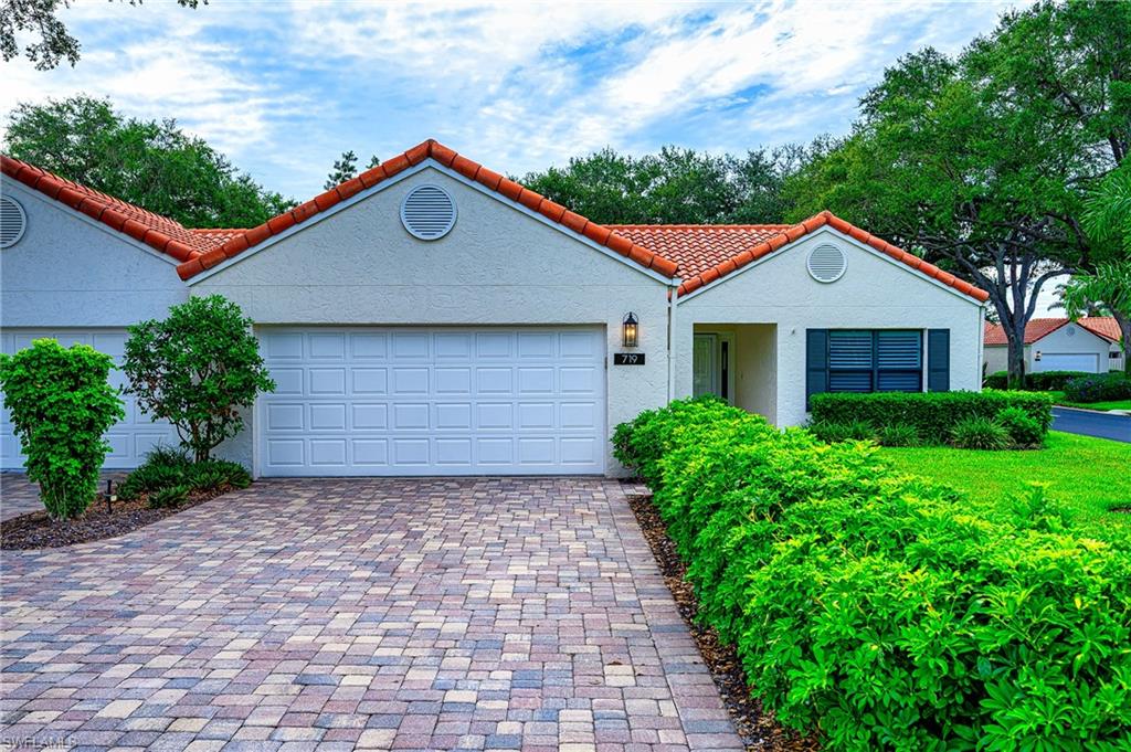 719 Reef Point Circle, Unit 13 Naples, FL 34108 - Photo 3 of 29 a front view of a house with a yard