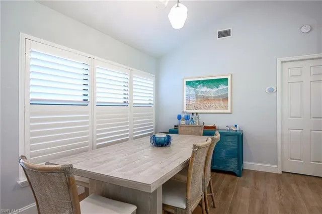 a dining room with furniture and window