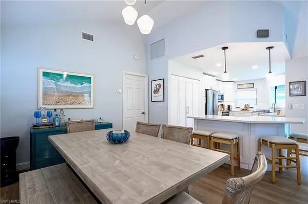 a kitchen with a table chairs and wooden floor