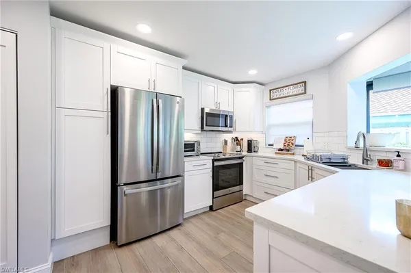 a kitchen with a refrigerator stove and sink