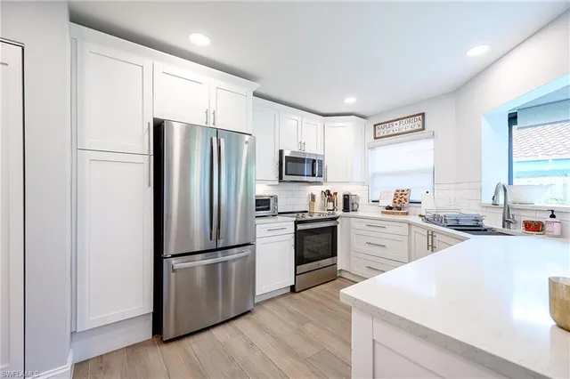 a kitchen with a refrigerator stove and sink
