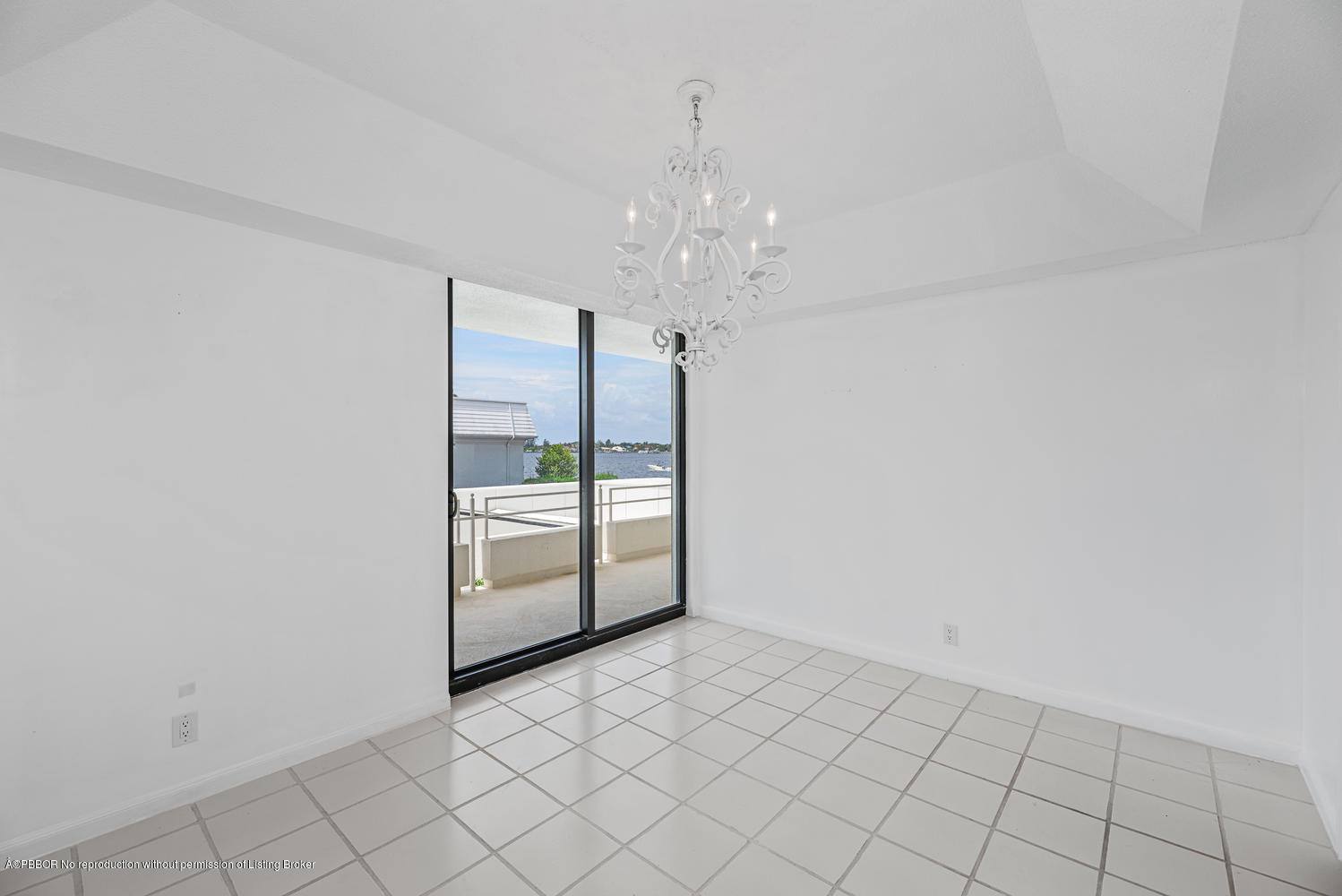 2150 Ibis Isle Road, Unit 8 Palm Beach, FL 33480 - Photo 13 of 31 a view of an empty room with chandelier