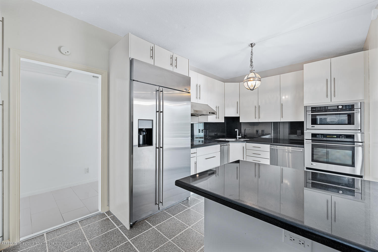 2150 Ibis Isle Road, Unit 8 Palm Beach, FL 33480 - Photo 16 of 31 a kitchen with stainless steel appliances a refrigerator sink and microwave