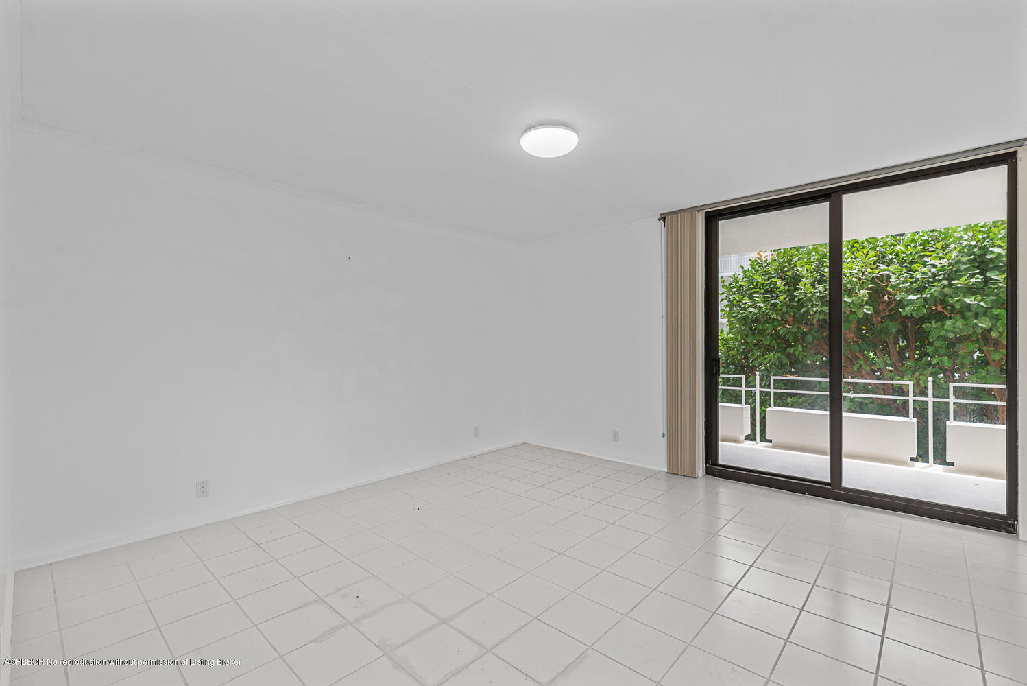 2150 Ibis Isle Road, Unit 8 Palm Beach, FL 33480 - Photo 9 of 31 an empty room with sliding glass door and mountain view