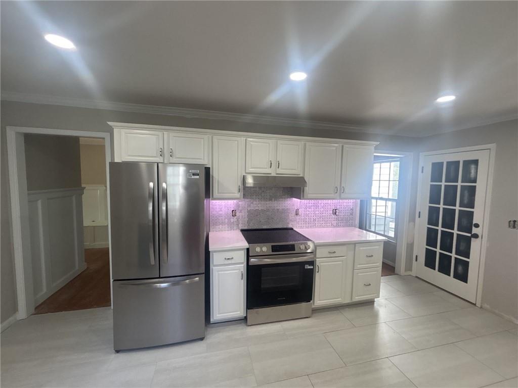 567 Leah Drive Powder Springs, GA 30127 - Photo 5 of 5 a kitchen with stainless steel appliances granite countertop a refrigerator sink and stove