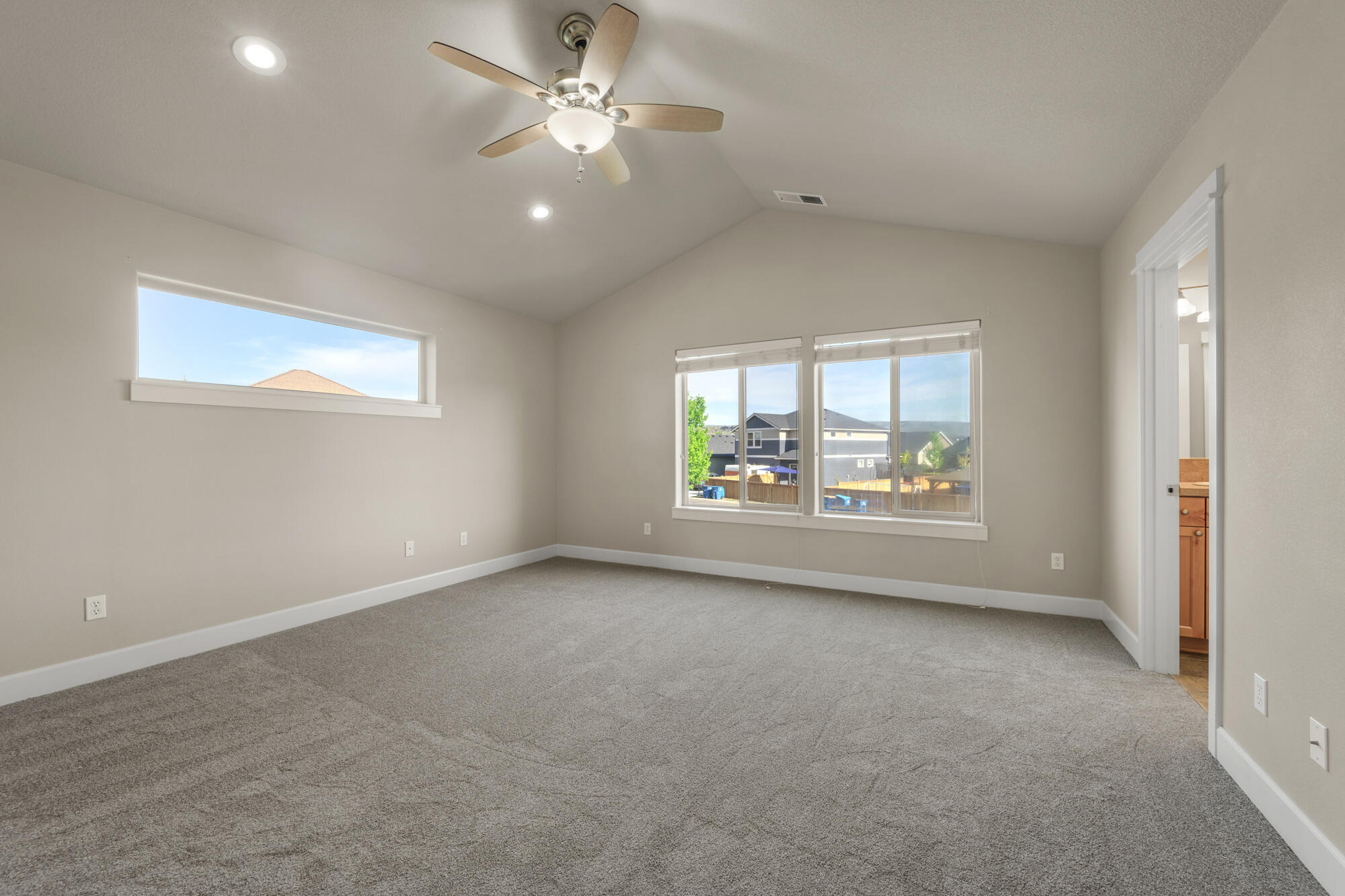 1402 Northeast Hudspeth Road Prineville, OR 97754 - Photo 15 of 36 an empty room with windows and ceiling fan