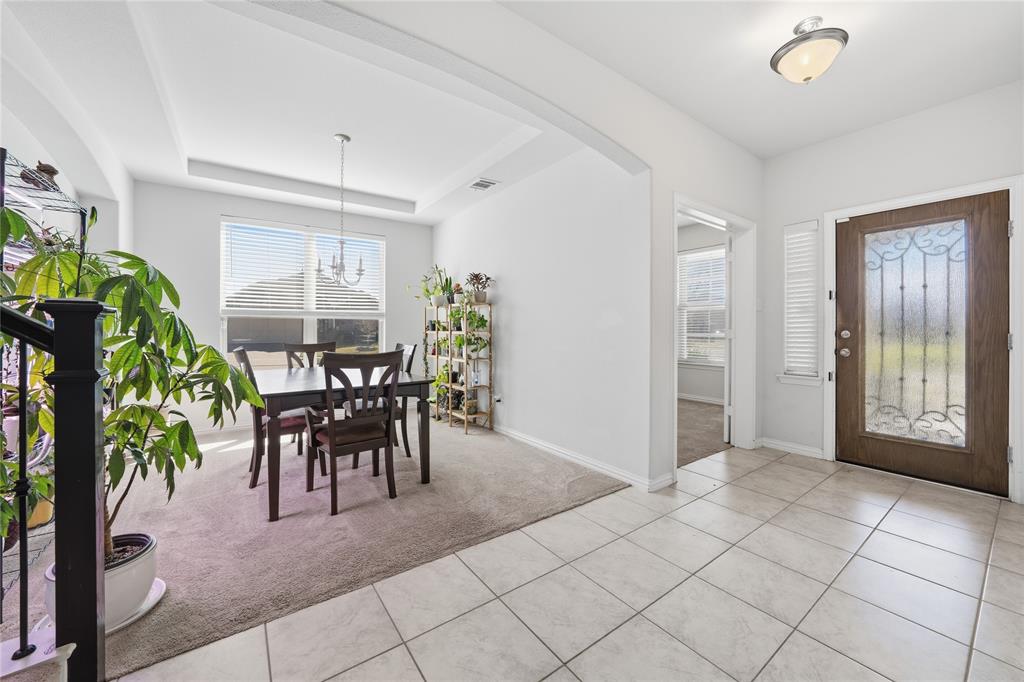 4542 Kipling Avenue Aubrey, TX 76227 - Photo 2 of 34 a view of a dining room with furniture and a potted plant