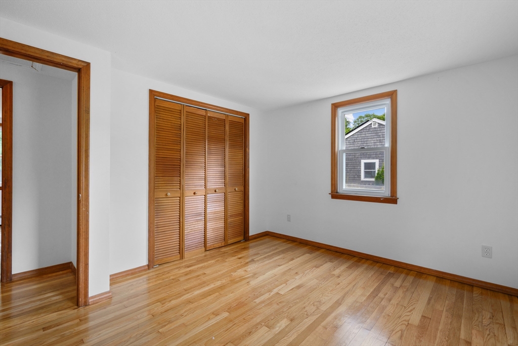 296 Buckskin Path Barnstable, MA 02632 - Photo 15 of 32 a view of an empty room with wooden floor and a window