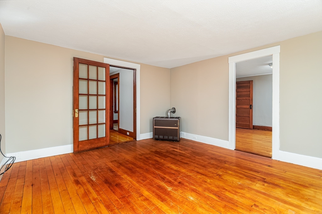 306 Franklin Road Fitchburg, MA 01420 - Photo 17 of 32 a view of empty room with wooden floor and fan