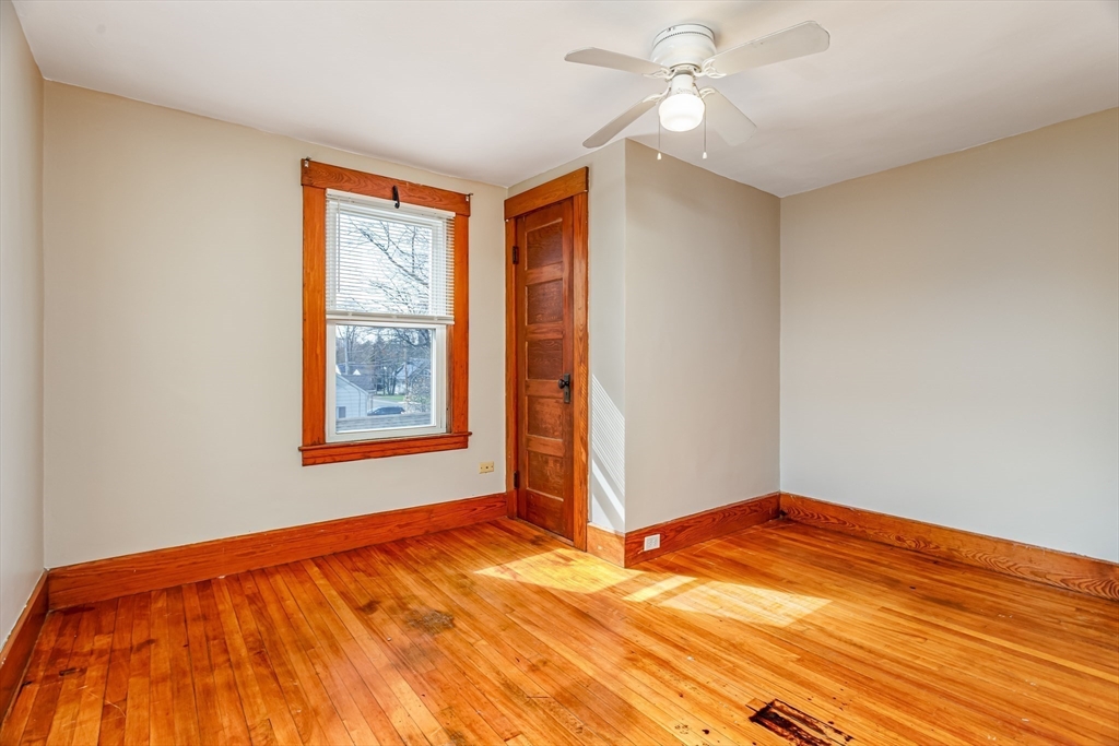 306 Franklin Road Fitchburg, MA 01420 - Photo 18 of 32 an empty room with a window and ceiling fan