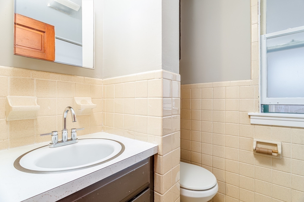 306 Franklin Road Fitchburg, MA 01420 - Photo 25 of 32 a bathroom with a sink a toilet and a mirror