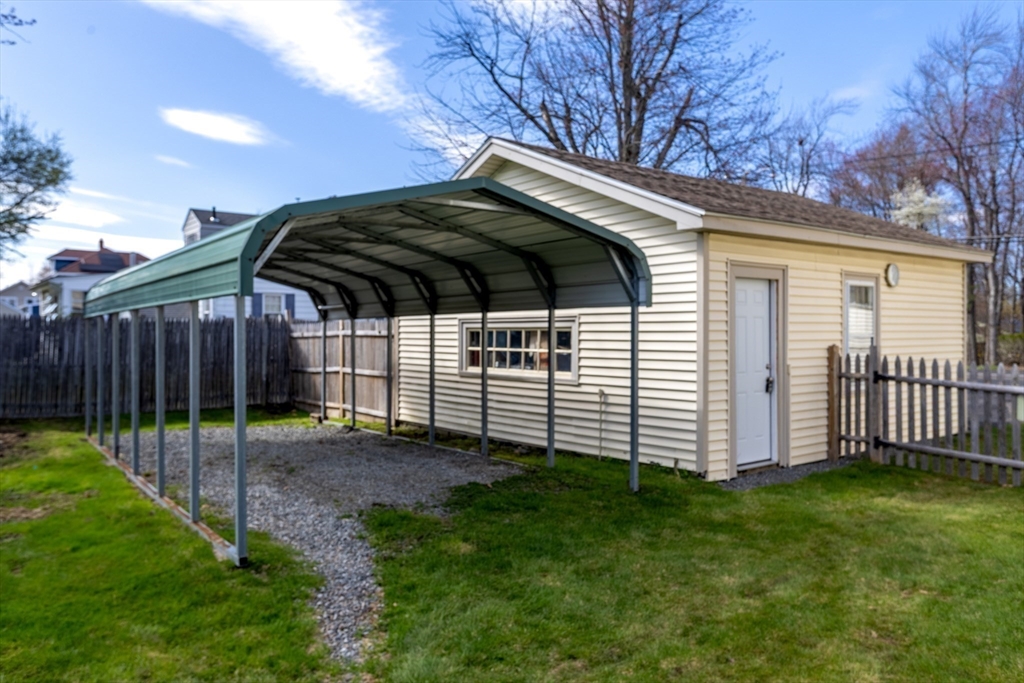 306 Franklin Road Fitchburg, MA 01420 - Photo 30 of 32 a view of a backyard with a barbeque grill and wooden fence