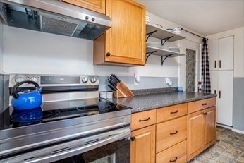 306 Franklin Road Fitchburg, MA 01420 - Photo 7 of 32 a kitchen with white cabinets and appliances