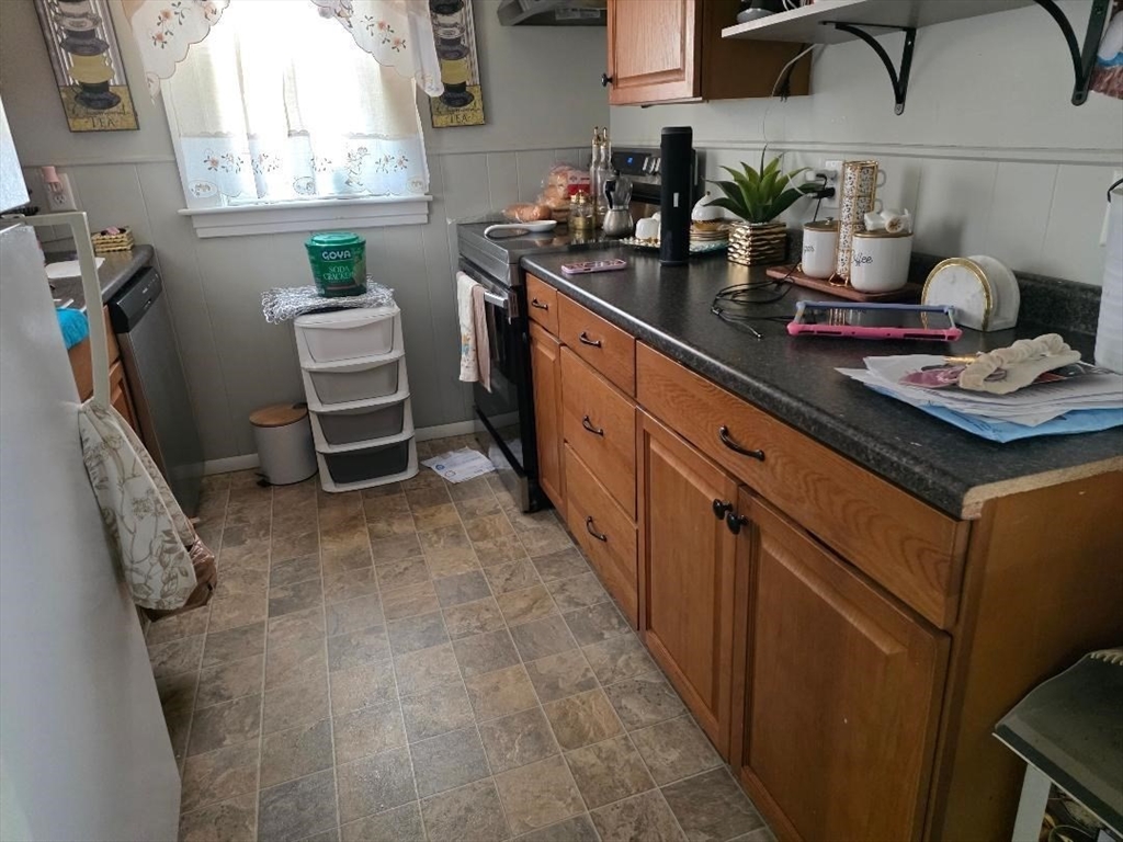 306 Franklin Road Fitchburg, MA 01420 - Photo 9 of 32 a kitchen with stainless steel appliances a sink stove and cabinets