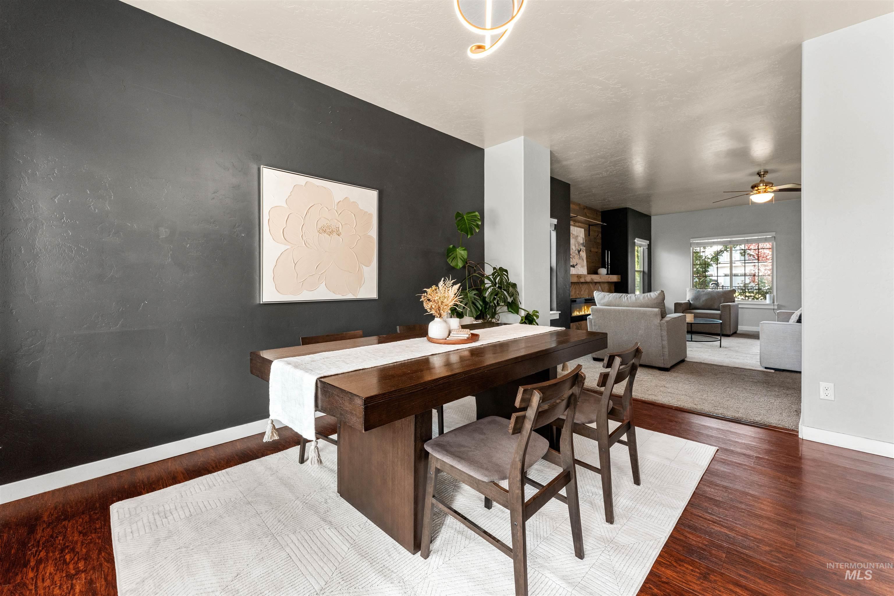 37 East Ensenada Drive Meridian, ID 83646 - Photo 12 of 46 Dining room with dark wood-style flooring, a ceiling fan, and a textured ceiling