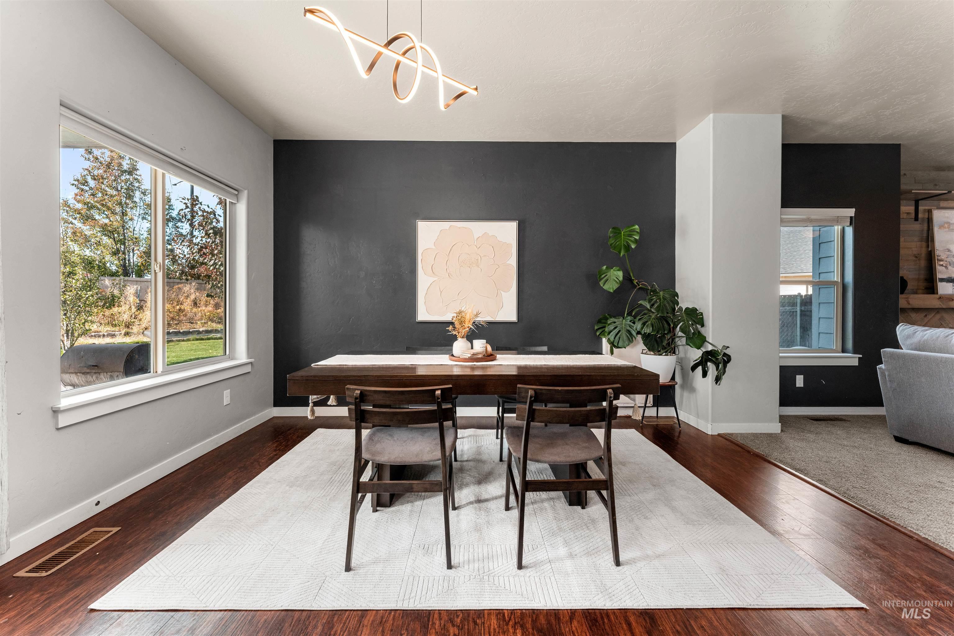 37 East Ensenada Drive Meridian, ID 83646 - Photo 13 of 46 Dining area with dark wood-style flooring and a chandelier