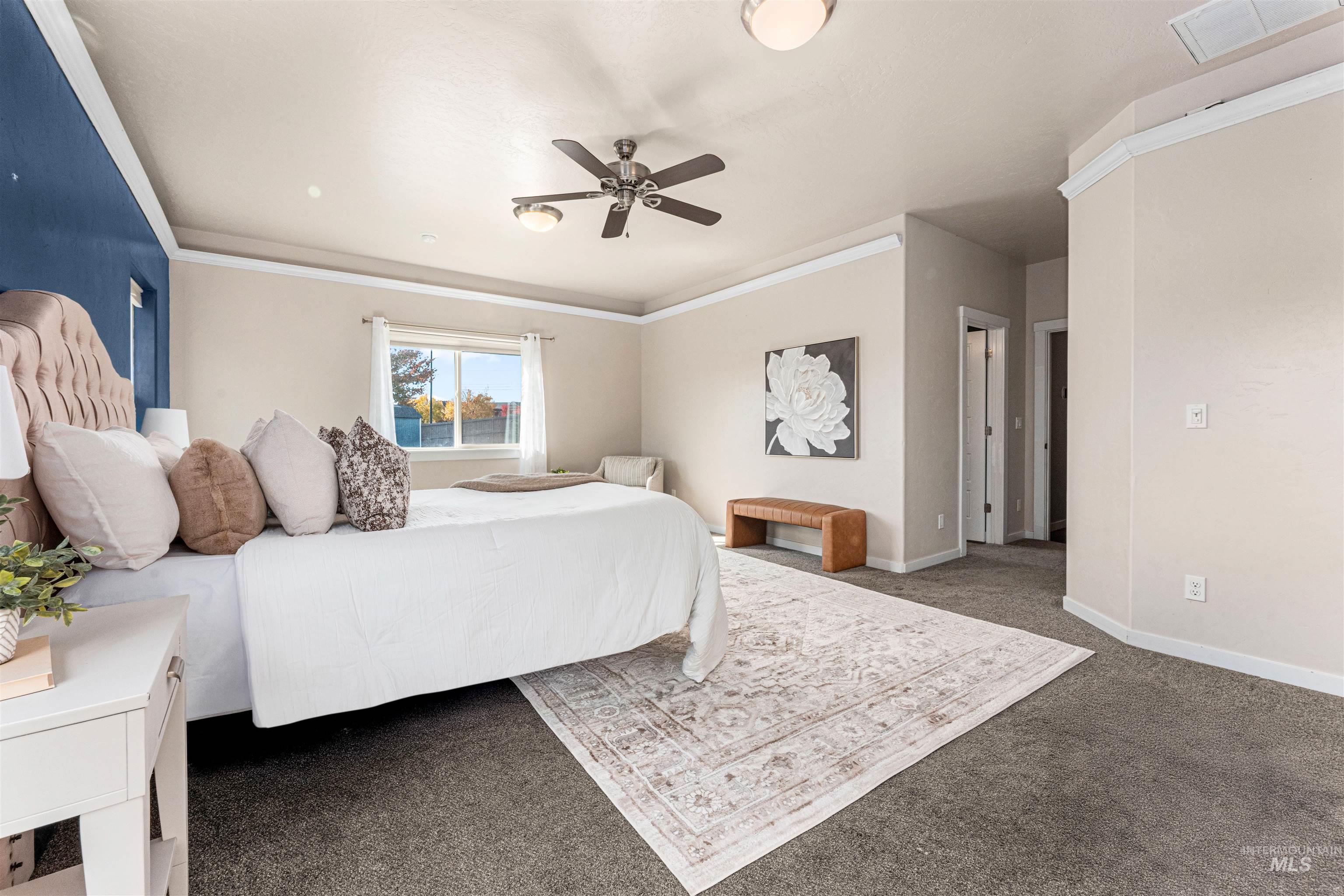 37 East Ensenada Drive Meridian, ID 83646 - Photo 19 of 46 Bedroom with dark colored carpet, a ceiling fan, and crown molding