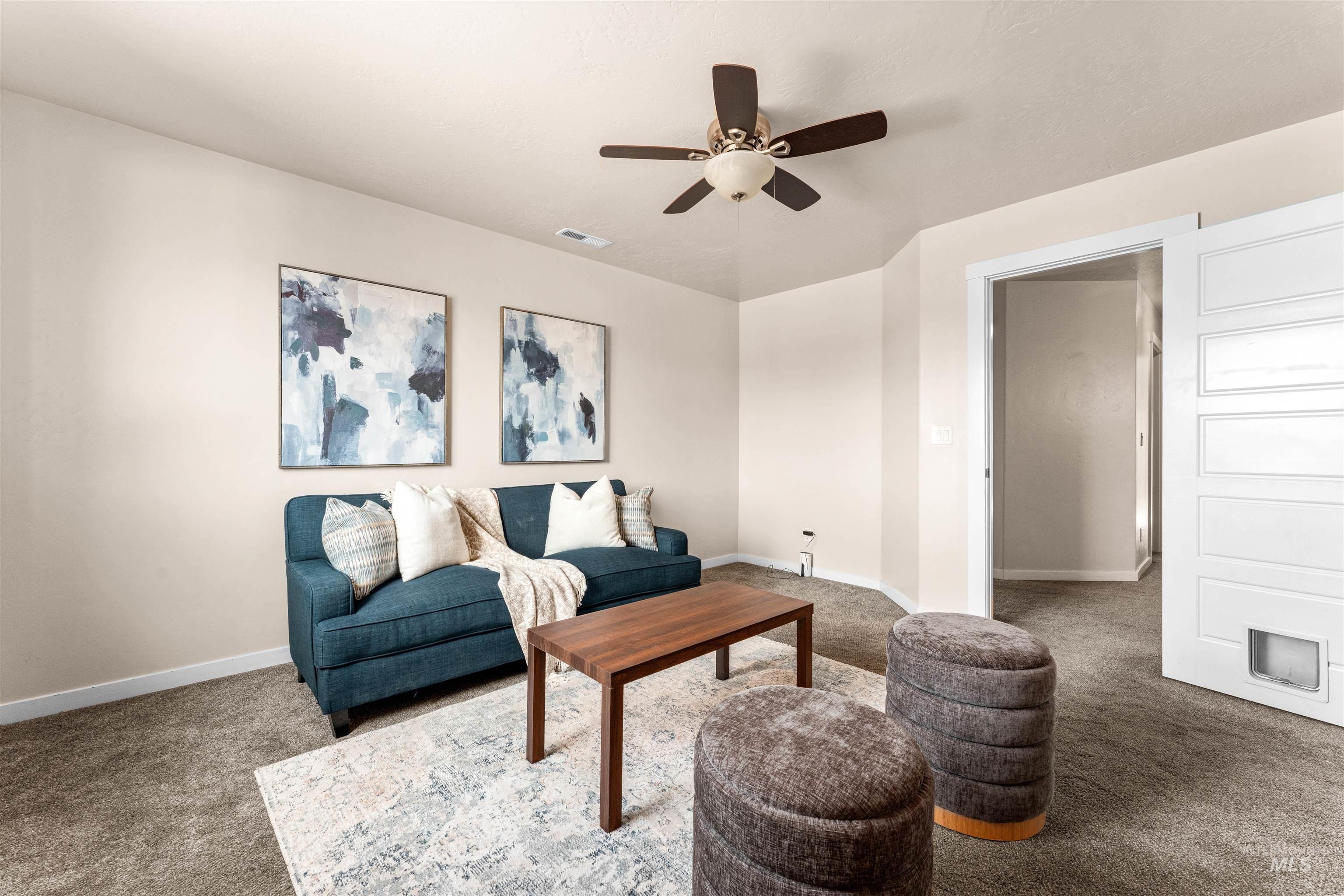 37 East Ensenada Drive Meridian, ID 83646 - Photo 23 of 46 Carpeted living room with a ceiling fan and baseboards