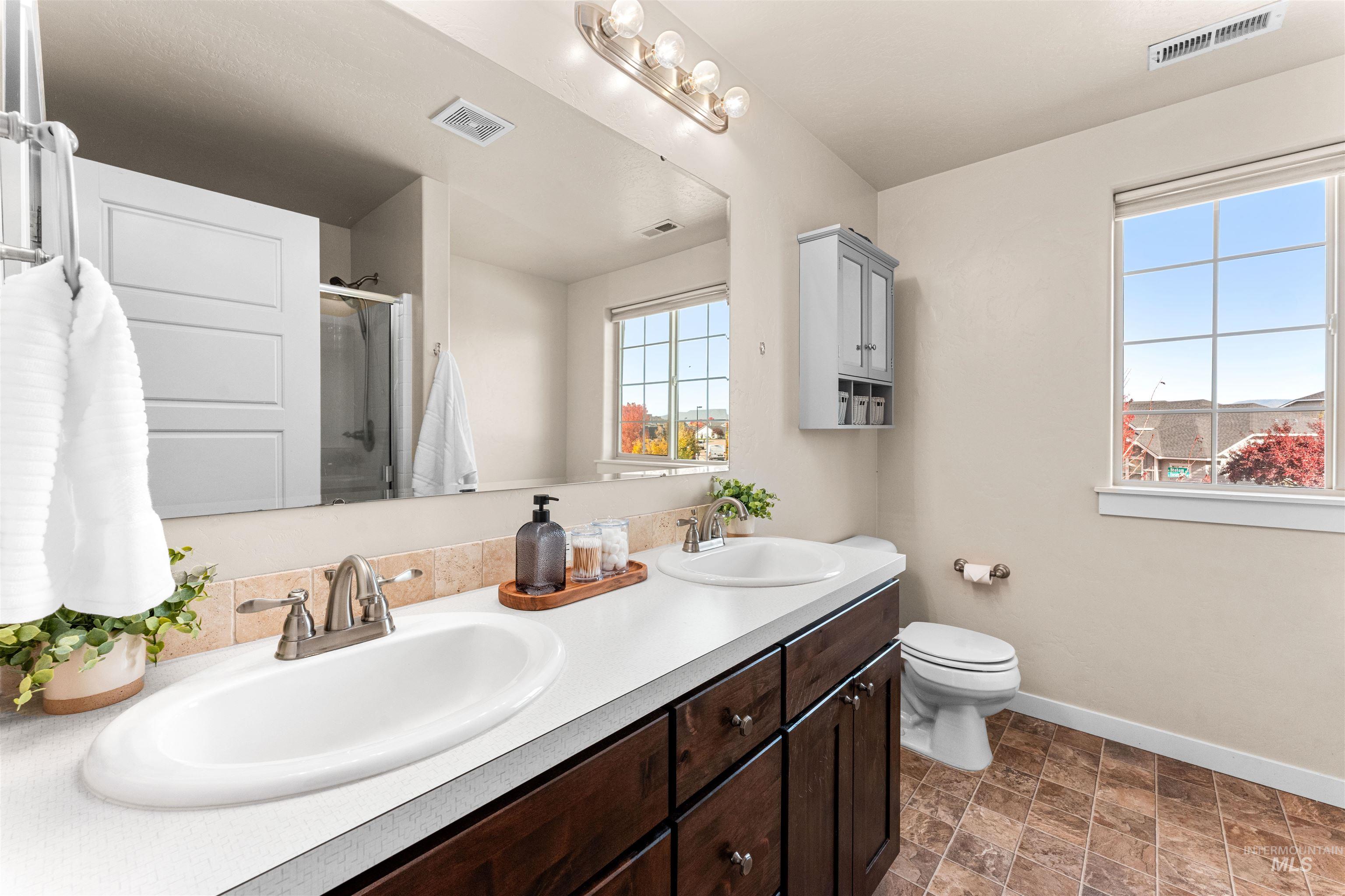 37 East Ensenada Drive Meridian, ID 83646 - Photo 26 of 46 Bathroom with a stall shower and double vanity