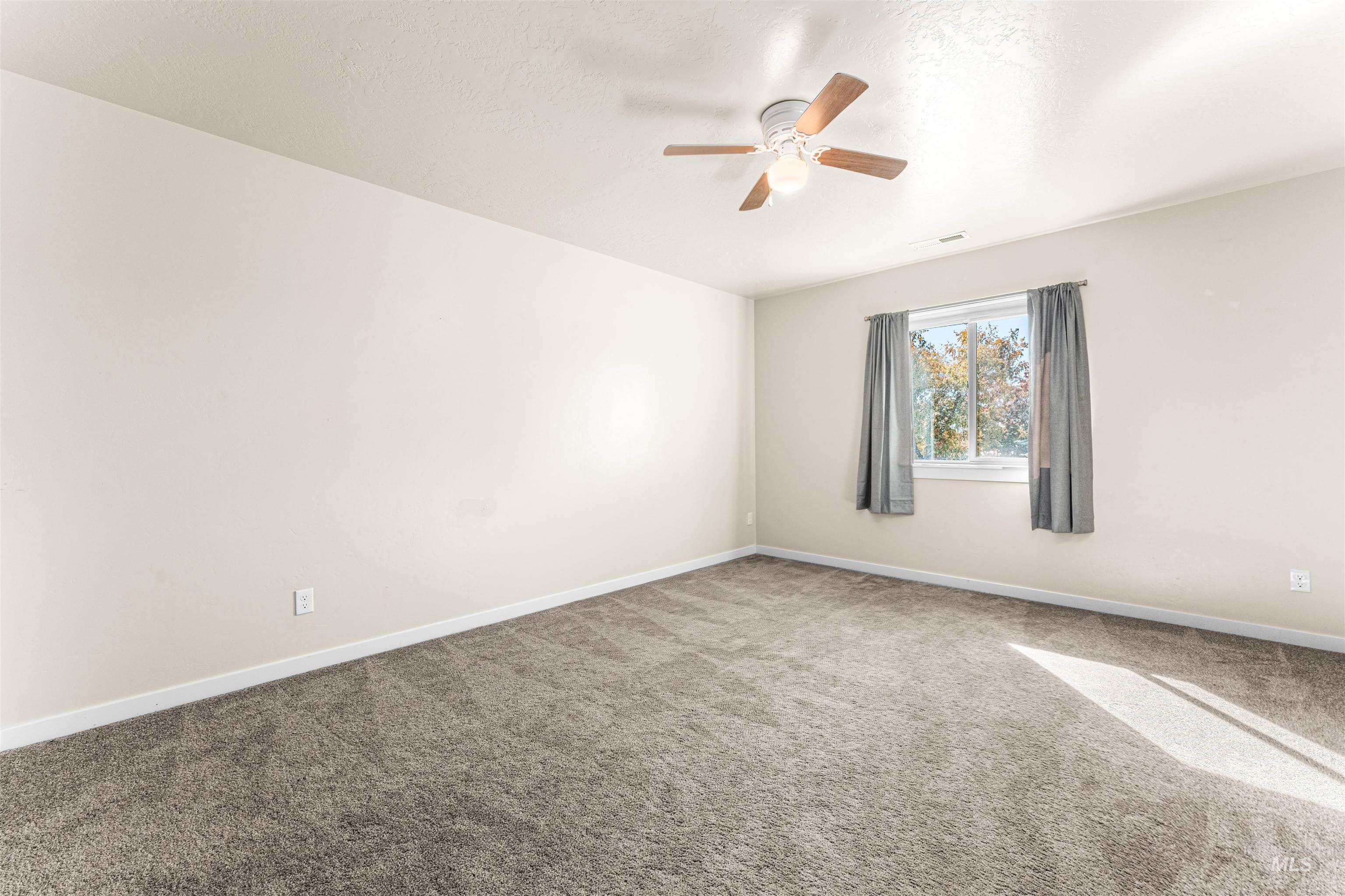 37 East Ensenada Drive Meridian, ID 83646 - Photo 30 of 46 Carpeted empty room with a ceiling fan and a textured ceiling