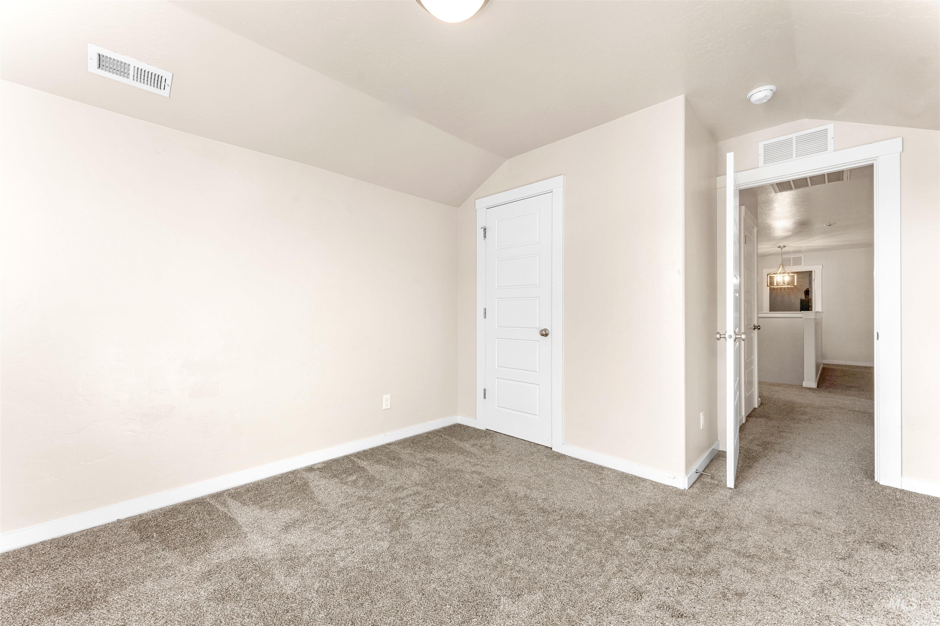 37 East Ensenada Drive Meridian, ID 83646 - Photo 34 of 46 Unfurnished bedroom featuring lofted ceiling and carpet