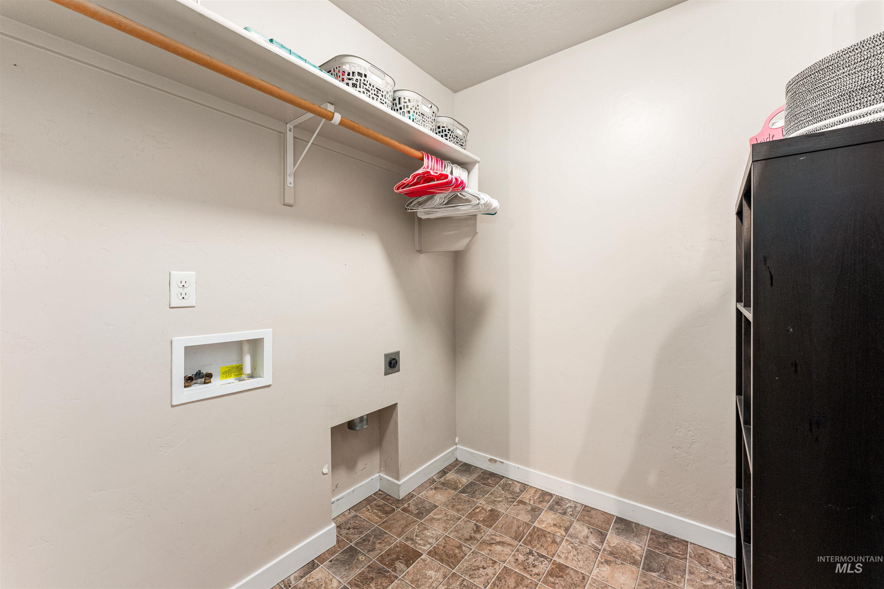 37 East Ensenada Drive Meridian, ID 83646 - Photo 39 of 46 Washroom featuring stone finish floors, hookup for a washing machine, and hookup for an electric dryer