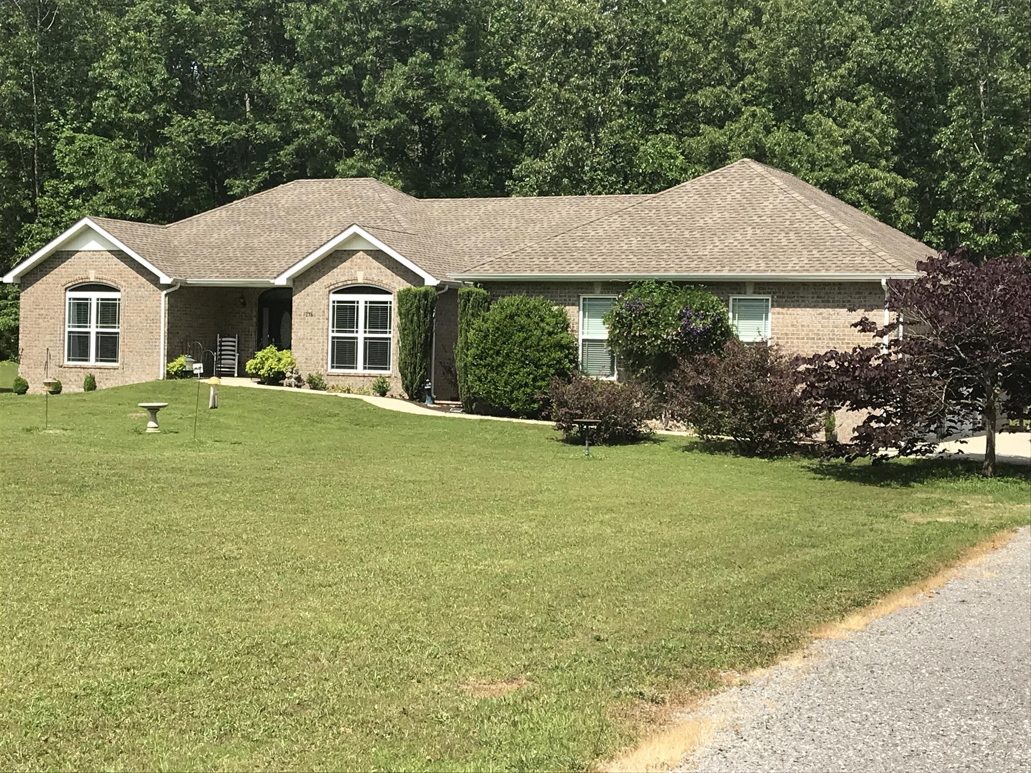 1276 Espy Road Manchester, TN 37355 - Photo 1 of 25 a house with trees in the background