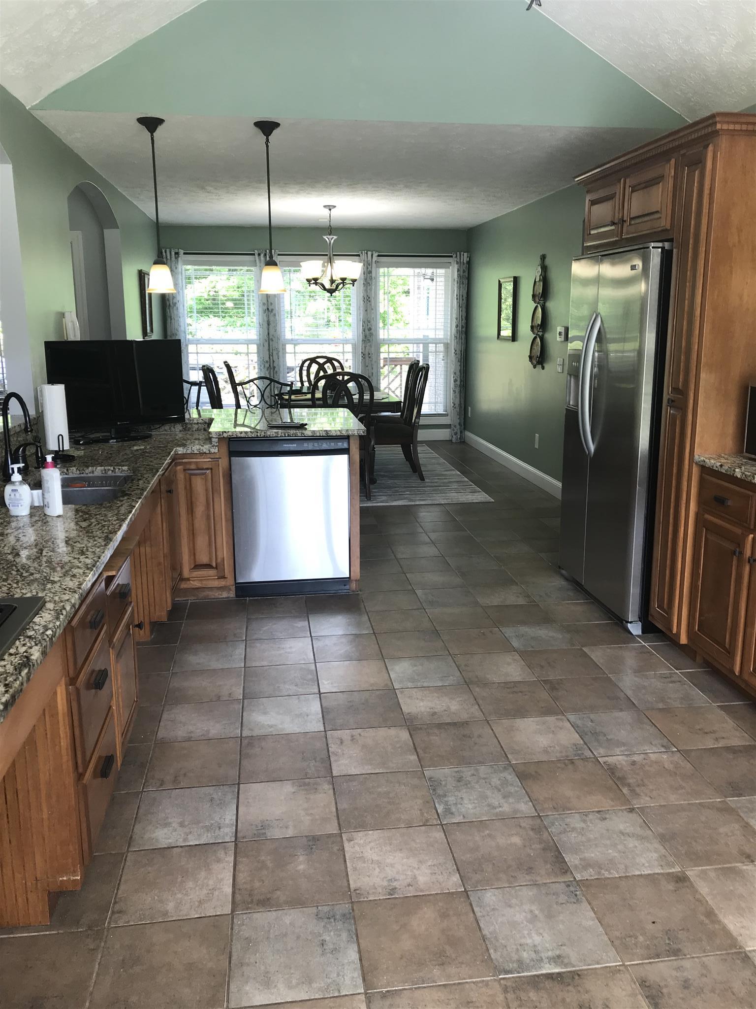 1276 Espy Road Manchester, TN 37355 - Photo 6 of 25 a kitchen with stainless steel appliances granite countertop a stove a sink and a refrigerator