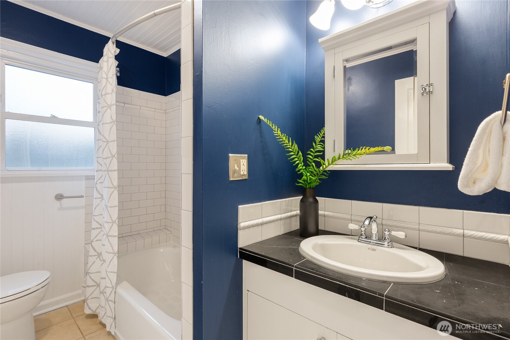 16406 Sylvester Road Southwest Burien, WA 98166 - Photo 12 of 28 a bathroom with a sink and a mirror