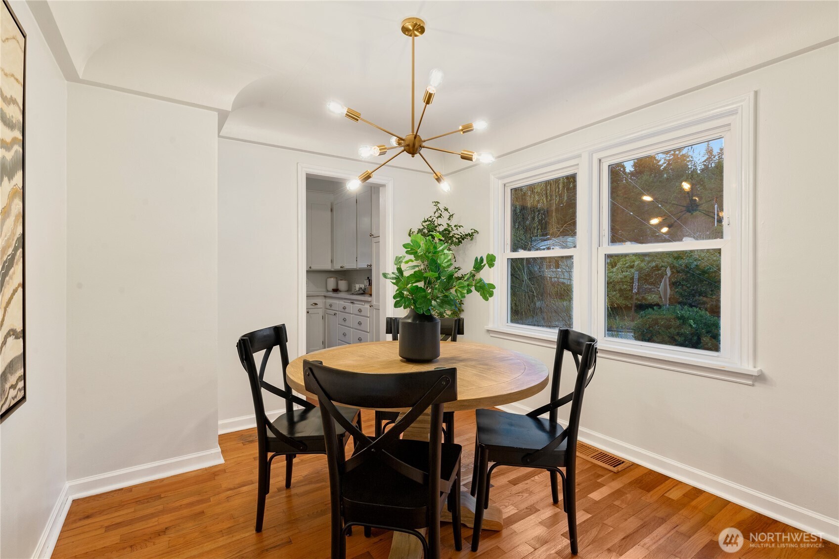 16406 Sylvester Road Southwest Burien, WA 98166 - Photo 5 of 28 a dining room with furniture potted plants and wooden floor