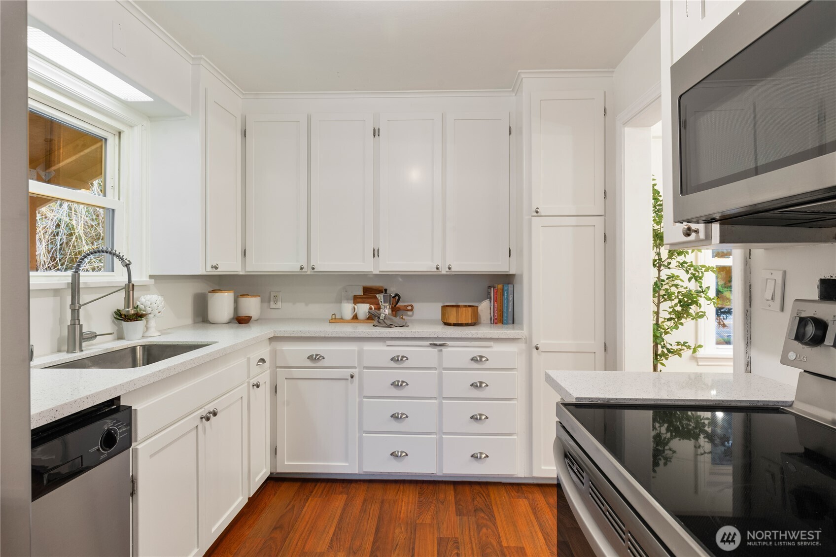 16406 Sylvester Road Southwest Burien, WA 98166 - Photo 8 of 28 a kitchen with granite countertop a sink window and cabinets