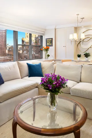 a living room with furniture and flowers