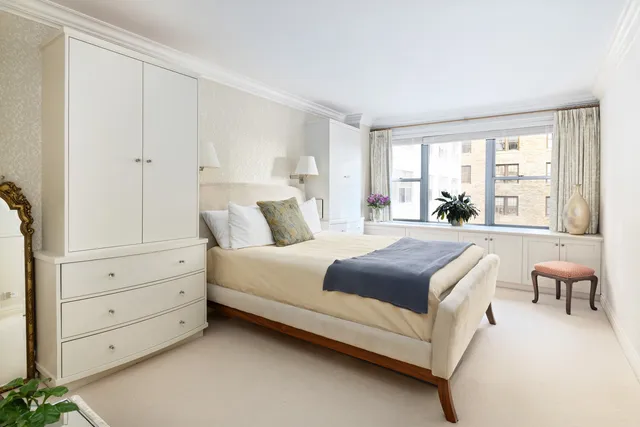 a bedroom with a large bed and furniture