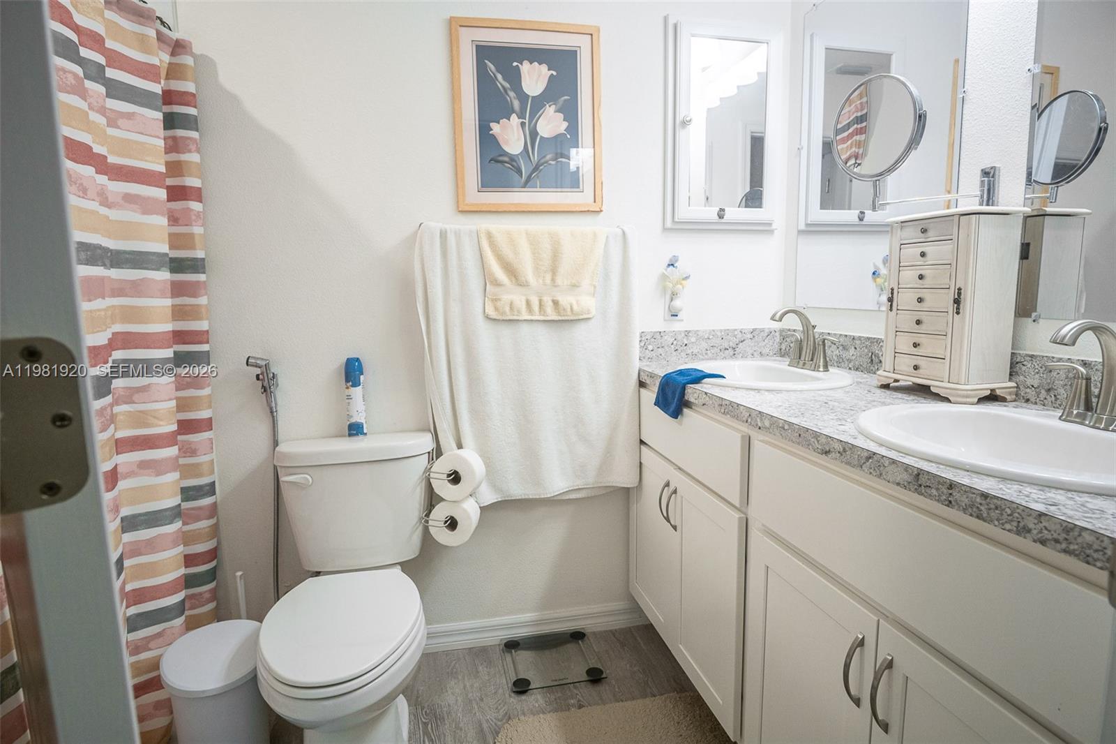1123 East Bucknell Avenue Inverness, FL 34450 - Photo 12 of 13 a bathroom with a granite countertop toilet sink and mirror