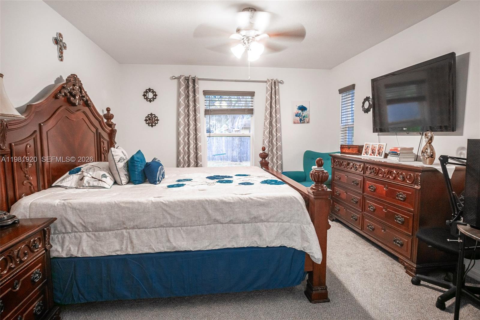 1123 East Bucknell Avenue Inverness, FL 34450 - Photo 13 of 13 a bedroom with a bed and a flat tv screen on dresser