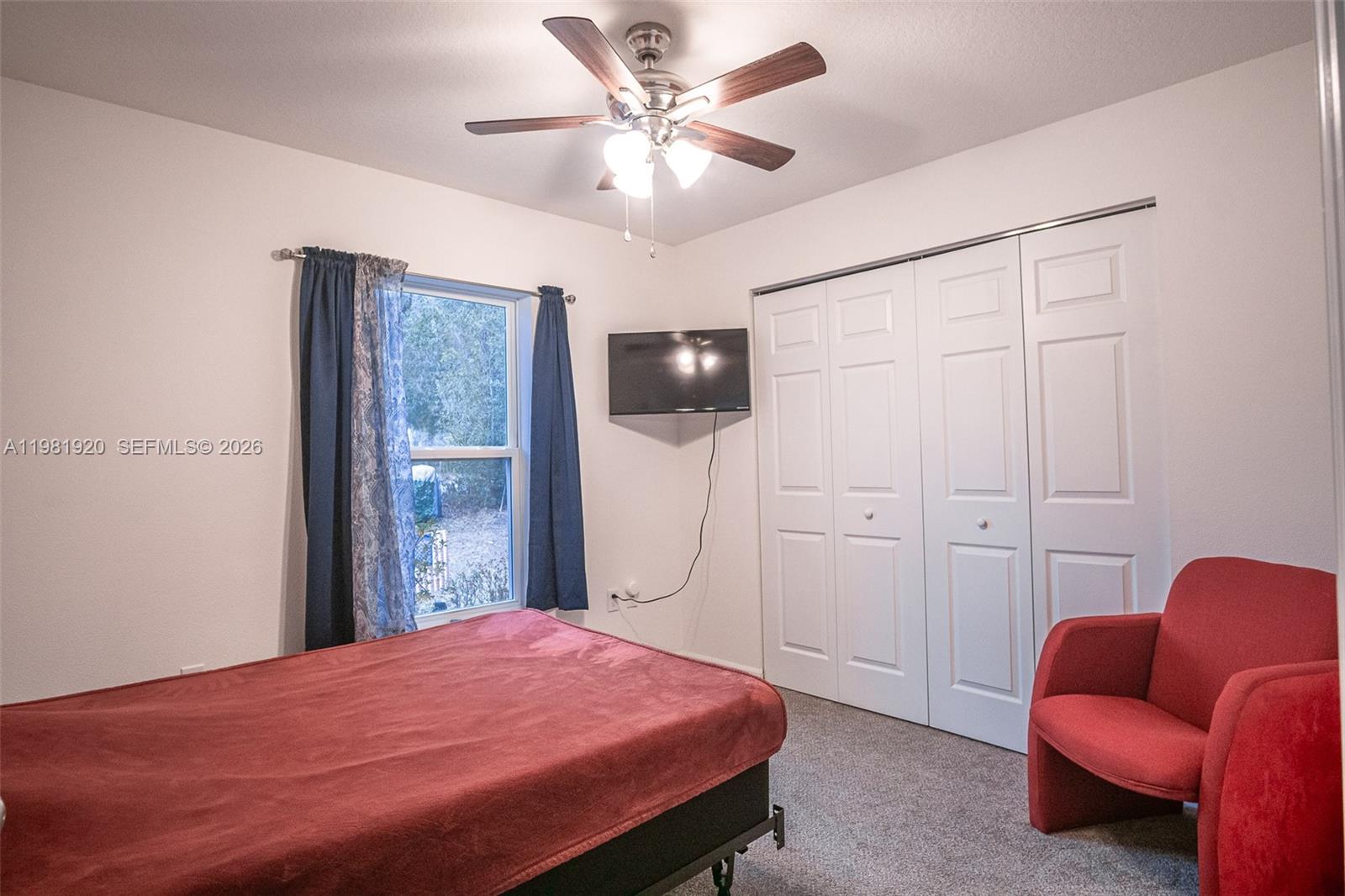 1123 East Bucknell Avenue Inverness, FL 34450 - Photo 5 of 13 a bedroom with a bed and a chandelier