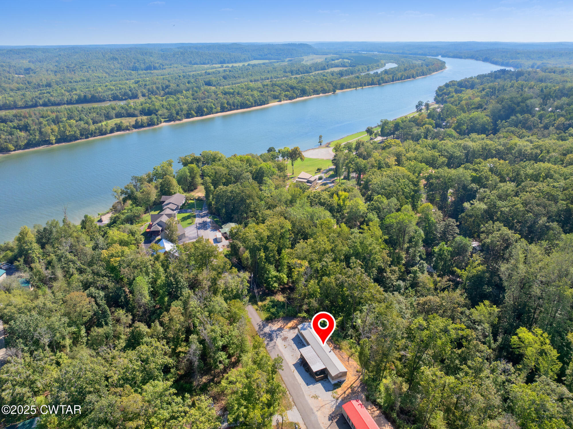 an aerial view of a houses with a lake view