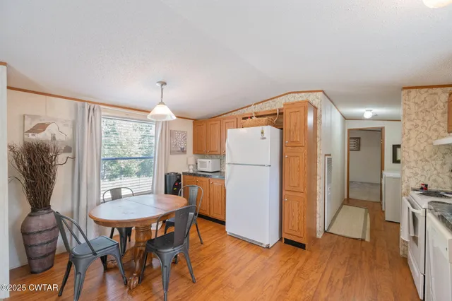 a dining room with furniture a window and wooden floor