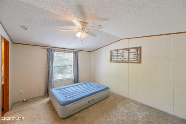 a view of room with window and ceiling fan