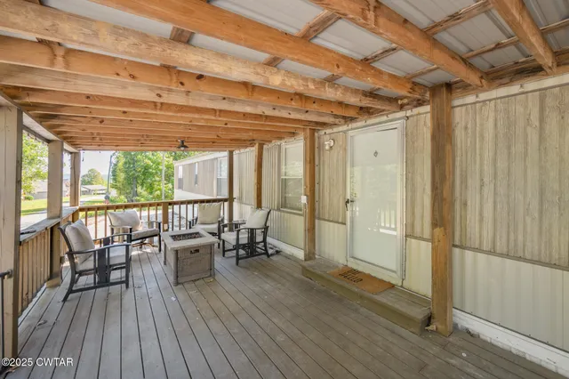 a view of a patio with table and chairs