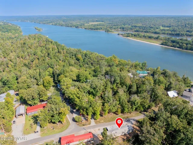 an aerial view of a houses with a lake view