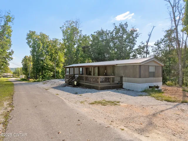 a view of a house with a yard covered with snow in the background
