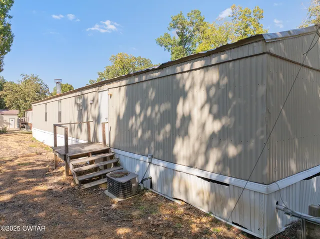 a backyard of a house with outdoor seating