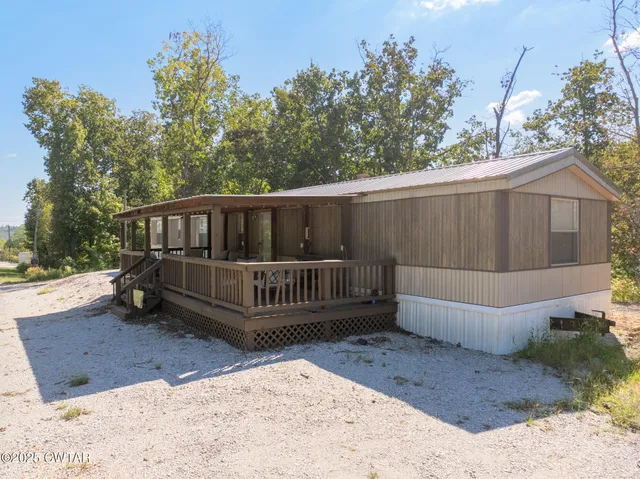 a view of a deck with a bench in a yard